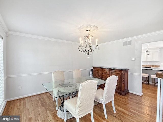 13225 Manor S, Mount Airy, MD 21771 - dining room featuring light wood-type flooring, crown molding, baseboards, and a chandelier