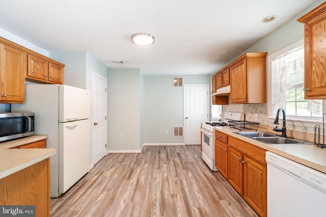 403 S Brynwood Dr, Browns Mills, NJ 08015 - kitchen featuring white appliances, a sink, light wood finished floors, under cabinet range hood, and light countertops