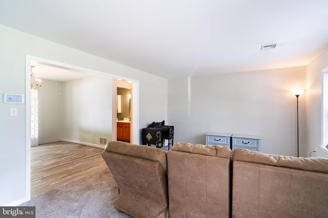 403 S Brynwood Dr, Browns Mills, NJ 08015 - living area with a chandelier, light carpet, light wood-style floors, and baseboards