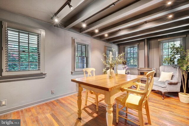323 N Patrick St, Alexandria, VA 22314 - dining room featuring baseboards, wood finished floors, rail lighting, and beamed ceiling