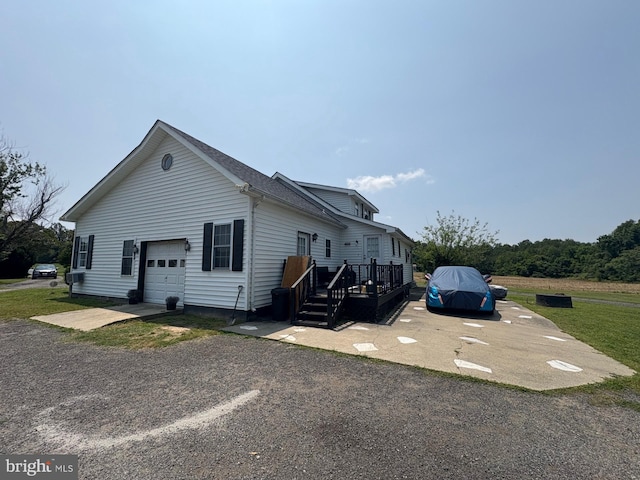 6525 Nomini Hall Rd, Hague, VA 22469 - view of property exterior featuring driveway, an attached garage, and a wooden deck