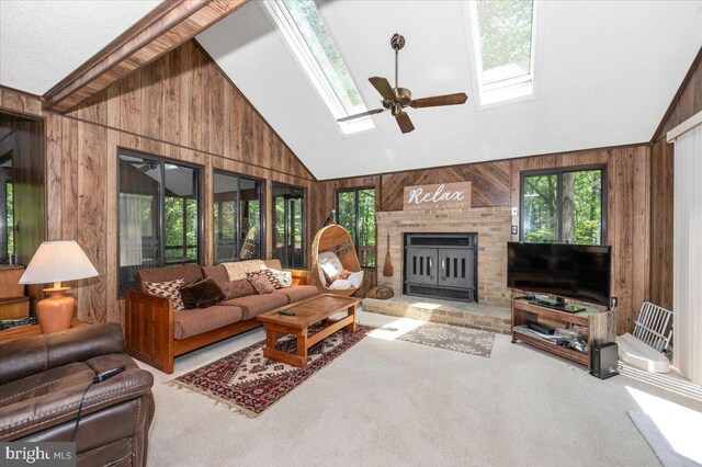19 Snowflake Ln, Hedgesville, WV 25427 - living room with a skylight, wooden walls, carpet flooring, a ceiling fan, and a brick fireplace