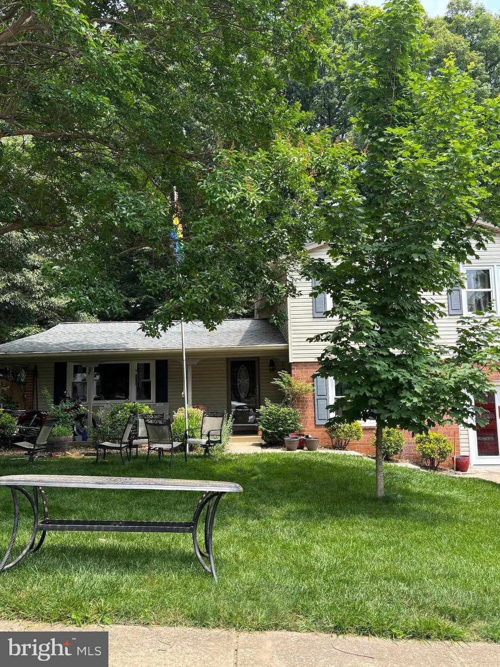 5267 Pumphrey Dr, Fairfax, VA 22032 - view of front of home with a front yard, brick siding, and a porch