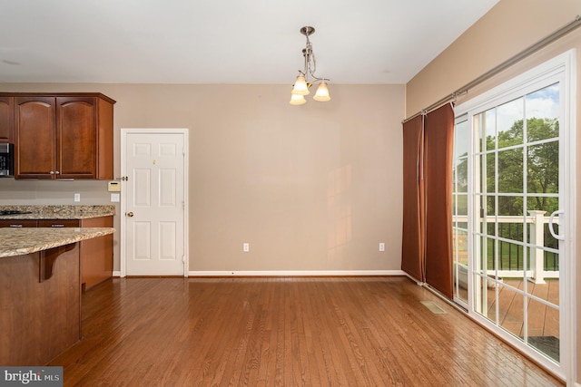 168 Joshua Dr, Hanover, PA 17331 - kitchen featuring wood finished floors, stainless steel microwave, a chandelier, and decorative light fixtures