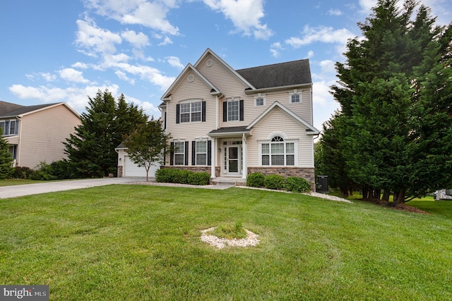 168 Joshua Dr, Hanover, PA 17331 - traditional-style house featuring concrete driveway, an attached garage, a front yard, and stone siding