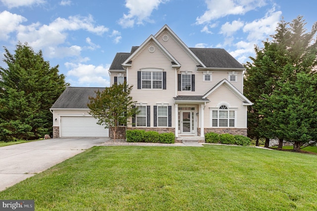 168 Joshua Dr, Hanover, PA 17331 - view of front of property featuring stone siding, an attached garage, concrete driveway, and a front yard
