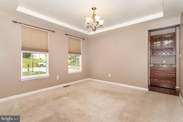 168 Joshua Dr, Hanover, PA 17331 - empty room featuring a tray ceiling, a chandelier, and light carpet