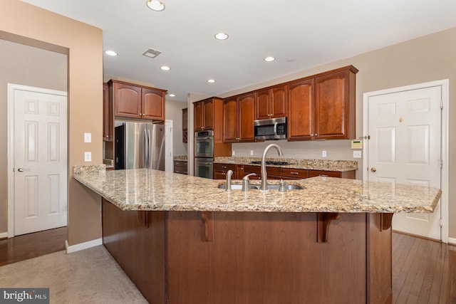 168 Joshua Dr, Hanover, PA 17331 - kitchen with appliances with stainless steel finishes, a peninsula, a kitchen breakfast bar, light stone counters, and recessed lighting