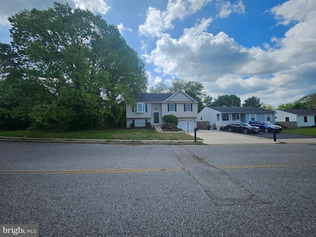 1139 Bradley Rd, Pasadena, MD 21122 - raised ranch featuring an attached garage and concrete driveway