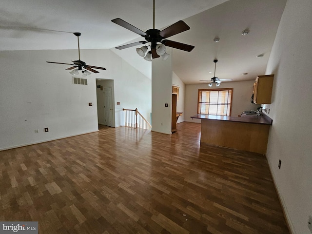 1139 Bradley Rd, Pasadena, MD 21122 - unfurnished living room featuring dark wood-type flooring, ceiling fan, a sink, baseboards, and high vaulted ceiling