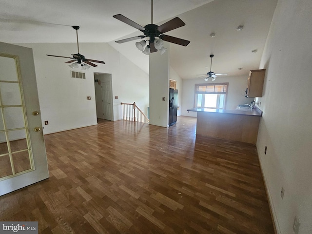 1139 Bradley Rd, Pasadena, MD 21122 - unfurnished living room featuring a ceiling fan, wood finished floors, and high vaulted ceiling