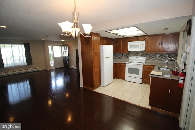 236 Vernon Rd, Monroe Township, NJ 08831 - kitchen with white appliances, a sink, a baseboard heating unit, open floor plan, and light wood-style floors