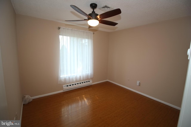 236 Vernon Rd, Monroe Township, NJ 08831 - unfurnished room with a baseboard radiator, wood finished floors, a ceiling fan, baseboards, and a textured ceiling