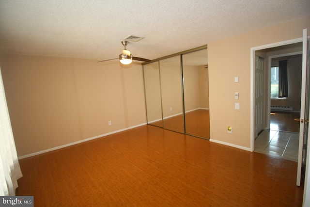 236 Vernon Rd, Monroe Township, NJ 08831 - unfurnished bedroom with baseboard heating, baseboards, a ceiling fan, and a textured ceiling