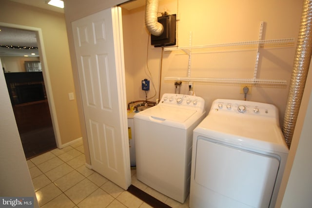 236 Vernon Rd, Monroe Township, NJ 08831 - laundry room with washing machine and clothes dryer, light tile patterned floors, and baseboards
