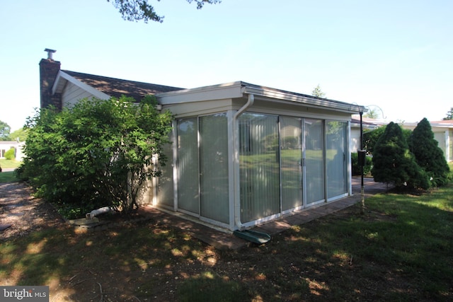 236 Vernon Rd, Monroe Township, NJ 08831 - view of property exterior with a sunroom and a chimney