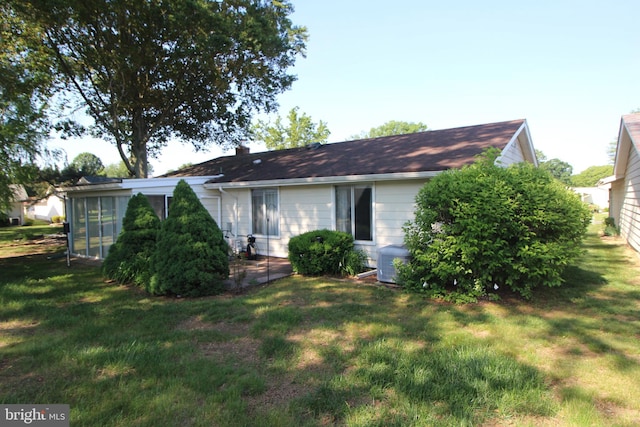 236 Vernon Rd, Monroe Township, NJ 08831 - back of property featuring a lawn, a sunroom, and a chimney