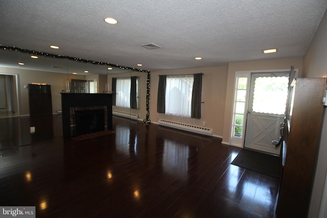 236 Vernon Rd, Monroe Township, NJ 08831 - unfurnished living room featuring a baseboard heating unit, a textured ceiling, recessed lighting, wood finished floors, and baseboards