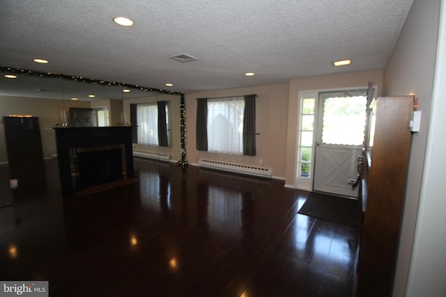 236 Vernon Rd, Monroe Township, NJ 08831 - foyer entrance with a baseboard radiator, a textured ceiling, dark wood-type flooring, recessed lighting, and baseboards