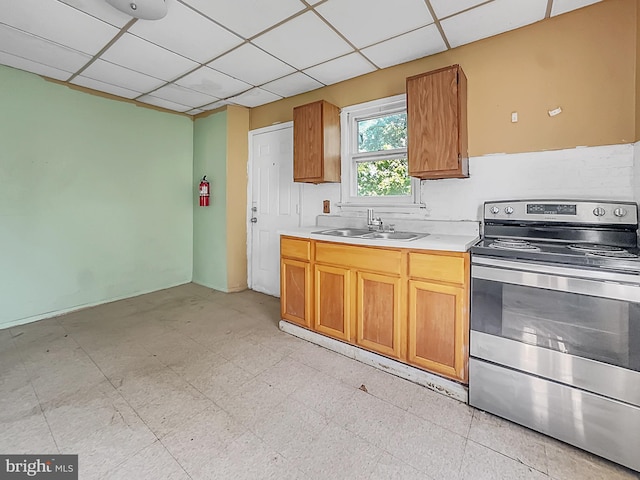 123 W Foundry St, Millville, NJ 08332 - kitchen with electric stove, a sink, light countertops, brown cabinets, and a drop ceiling