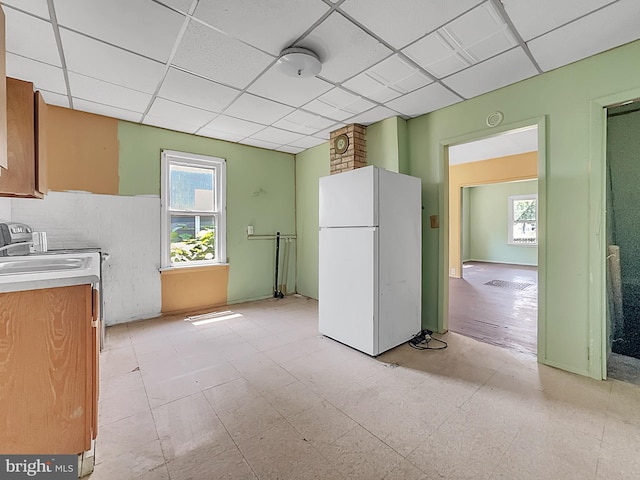 123 W Foundry St, Millville, NJ 08332 - kitchen featuring freestanding refrigerator, healthy amount of natural light, a drop ceiling, light flooring, and light countertops