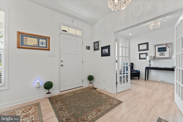 9400 Kinnerton Dr, Midlothian, VA 23112 - foyer featuring a chandelier, light wood finished floors, and baseboards