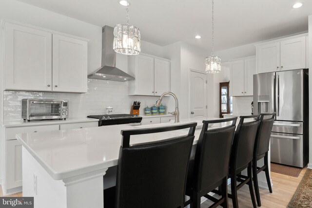 9400 Kinnerton Dr, Midlothian, VA 23112 - kitchen with wall chimney range hood, stainless steel appliances, a chandelier, decorative backsplash, and recessed lighting