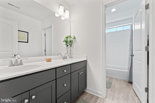 9400 Kinnerton Dr, Midlothian, VA 23112 - bathroom featuring double vanity, wood finished floors, shower / bath combo with shower curtain, baseboards, and recessed lighting