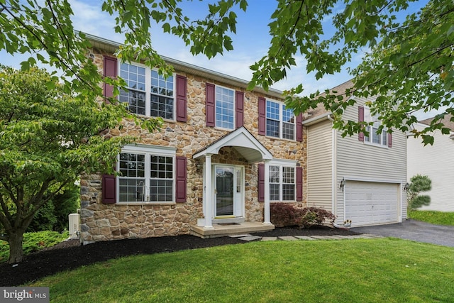 127 Watch Hill Rd, East Fallowfield Township, PA 19320 - view of front facade featuring stone siding, asphalt driveway, a front lawn, and an attached garage