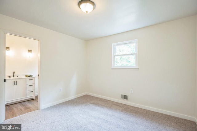 27136 Dogwood Ln, Mechanicsville, MD 20659 - unfurnished room with a sink, baseboards, and light colored carpet