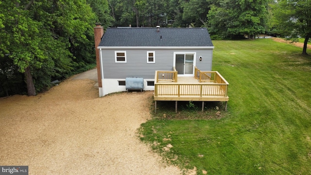 27136 Dogwood Ln, Mechanicsville, MD 20659 - rear view of house featuring a yard, a wooden deck, a chimney, oil tank, and a shingled roof