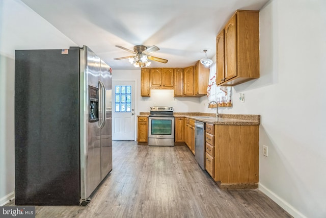 64 Poplar Ave, Warrington, PA 18976 - kitchen featuring stainless steel appliances, light wood-type flooring, a sink, and brown cabinetry