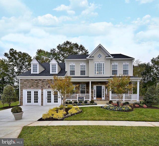 4420 Breidenbaugh Ln, Glen Arm, MD 21057 - view of front facade with stone siding, covered porch, a front yard, french doors, and concrete driveway