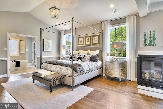 4420 Breidenbaugh Ln, Glen Arm, MD 21057 - bedroom featuring multiple windows, hardwood / wood-style flooring, vaulted ceiling, and a chandelier