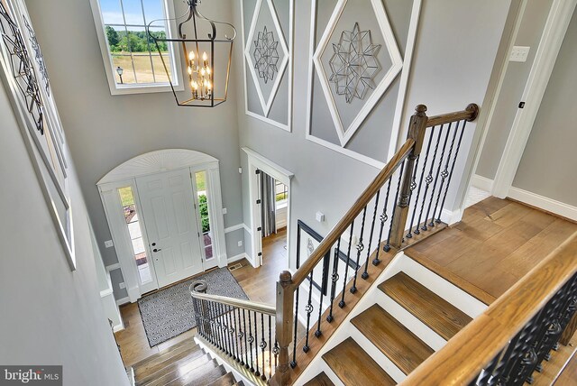 4420 Breidenbaugh Ln, Glen Arm, MD 21057 - foyer featuring a chandelier, wood finished floors, a towering ceiling, and stairway