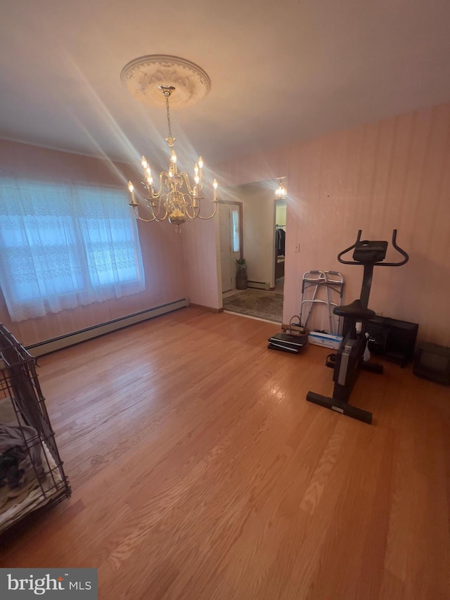 8 Cedar Rd, Mount Pocono, PA 18344 - exercise area featuring a baseboard heating unit, wood finished floors, and a chandelier