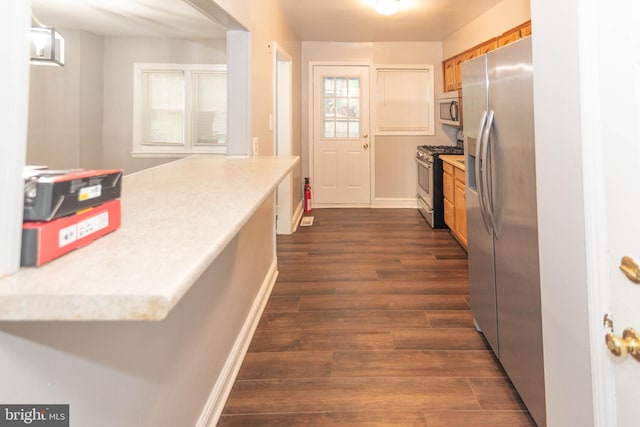 5603 Clearspring Rd, Baltimore, MD 21212 - kitchen featuring stainless steel appliances, dark wood-style flooring, light countertops, brown cabinets, and baseboards