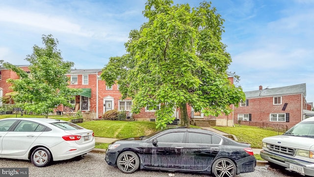 5603 Clearspring Rd, Baltimore, MD 21212 - townhome / multi-family property with a front lawn and brick siding