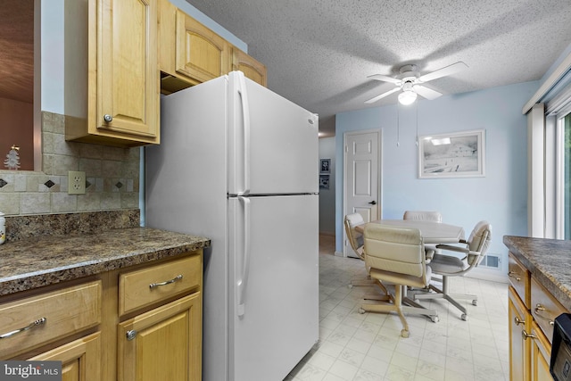 2 Cottonwood Dr, Barnegat, NJ 08005 - kitchen with freestanding refrigerator, dark countertops, a ceiling fan, light floors, and backsplash