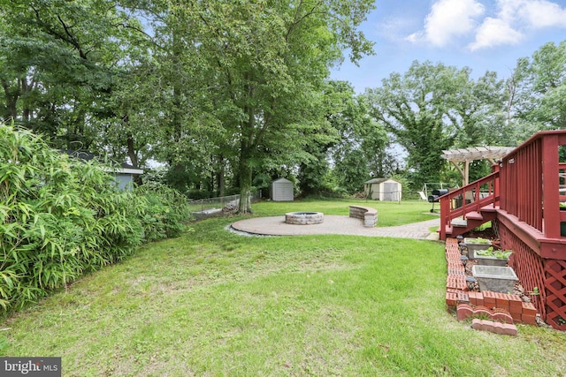 6937 Halleck St, District Heights, MD 20747 - view of yard featuring a storage unit, a fire pit, and stairway