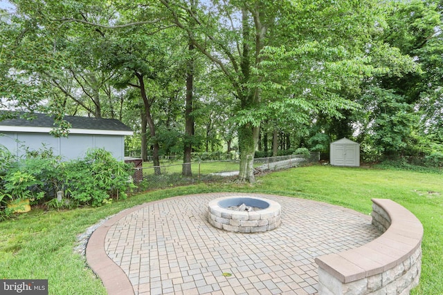 6937 Halleck St, District Heights, MD 20747 - view of patio / terrace with a fire pit, a storage unit, and view of wooded area