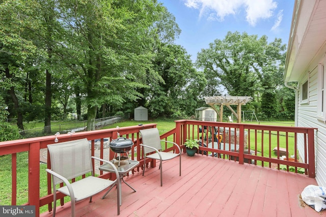 6937 Halleck St, District Heights, MD 20747 - wooden deck with a shed, view of scattered trees, a fenced backyard, and a playground