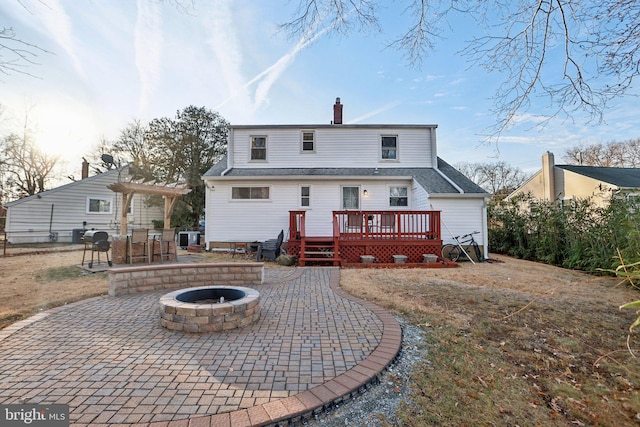 6937 Halleck St, District Heights, MD 20747 - rear view of house with an outdoor fire pit, a deck, a patio area, a pergola, and a chimney
