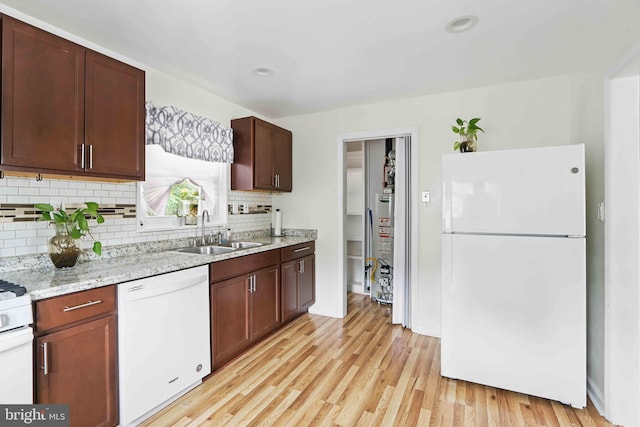 6937 Halleck St, District Heights, MD 20747 - kitchen with white appliances, decorative backsplash, light wood-style flooring, gas water heater, and light stone counters