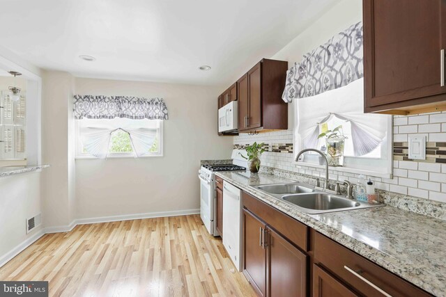6937 Halleck St, District Heights, MD 20747 - kitchen with white appliances, decorative backsplash, light wood-style flooring, light stone counters, and recessed lighting
