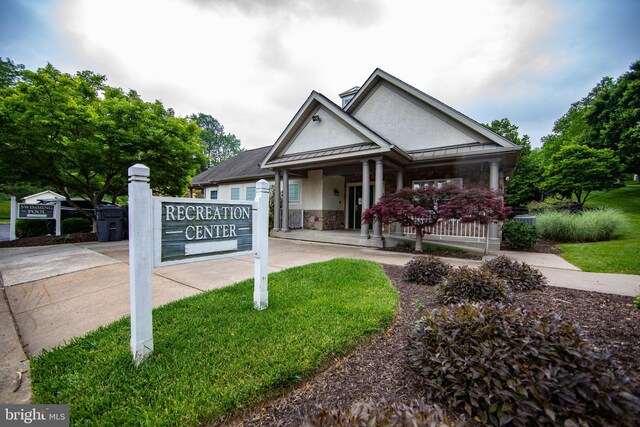 112 Jeffords Ct Unit 1601, Phoenixville, PA 19460 - view of front facade with a standing seam roof, stucco siding, covered porch, a metal roof, and a front yard