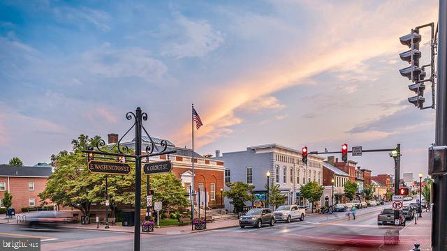 343 Anthem St, Ranson, WV 25438 - view of asphalt street with traffic lights, sidewalks, street lighting, and traffic signs