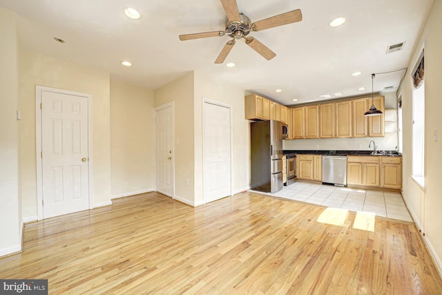 1030 Fairmont St NW Unit 204, Washington, DC 20001 - kitchen with stainless steel appliances, dark countertops, light wood-style floors, ceiling fan, and recessed lighting