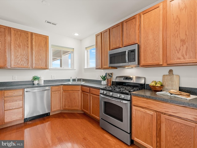 20005 Newry Dr Unit Y13, Rehoboth Beach, DE 19971 - kitchen with stainless steel appliances, light wood-type flooring, dark countertops, and recessed lighting