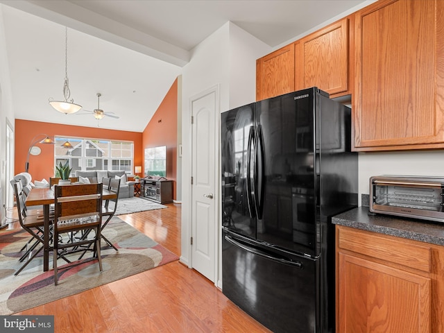 20005 Newry Dr Unit Y13, Rehoboth Beach, DE 19971 - kitchen with freestanding refrigerator, lofted ceiling, light wood-style floors, dark countertops, and open floor plan